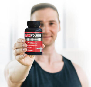 a man with vigrx max volume bottle in his hand